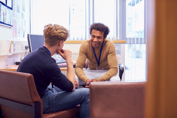 student talking to school counselor