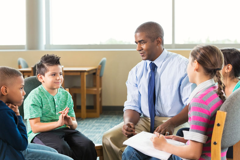 diverse students meeting with counselor