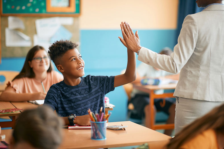 student high fiving his counselor