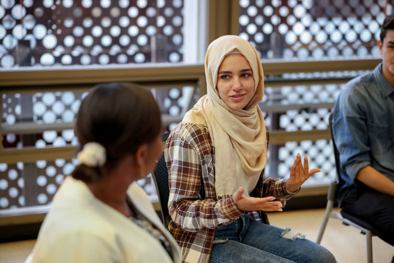 students talking in group setting