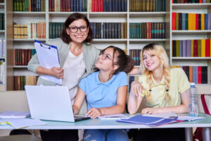 school counselor with girls in the library